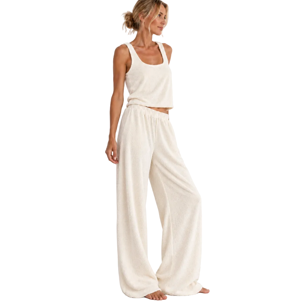 Angled view of the cream cotton Towelling Loungewear Set, Long, by Hostess the label, showing the relaxed tank and wide-leg pants on a model.