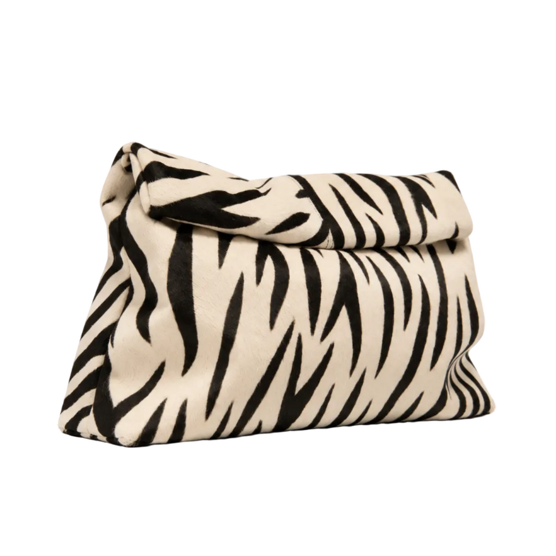 Model carrying The Zebra Clutch by Hostess the label, styled with a white V-neck T-shirt and denim shorts.