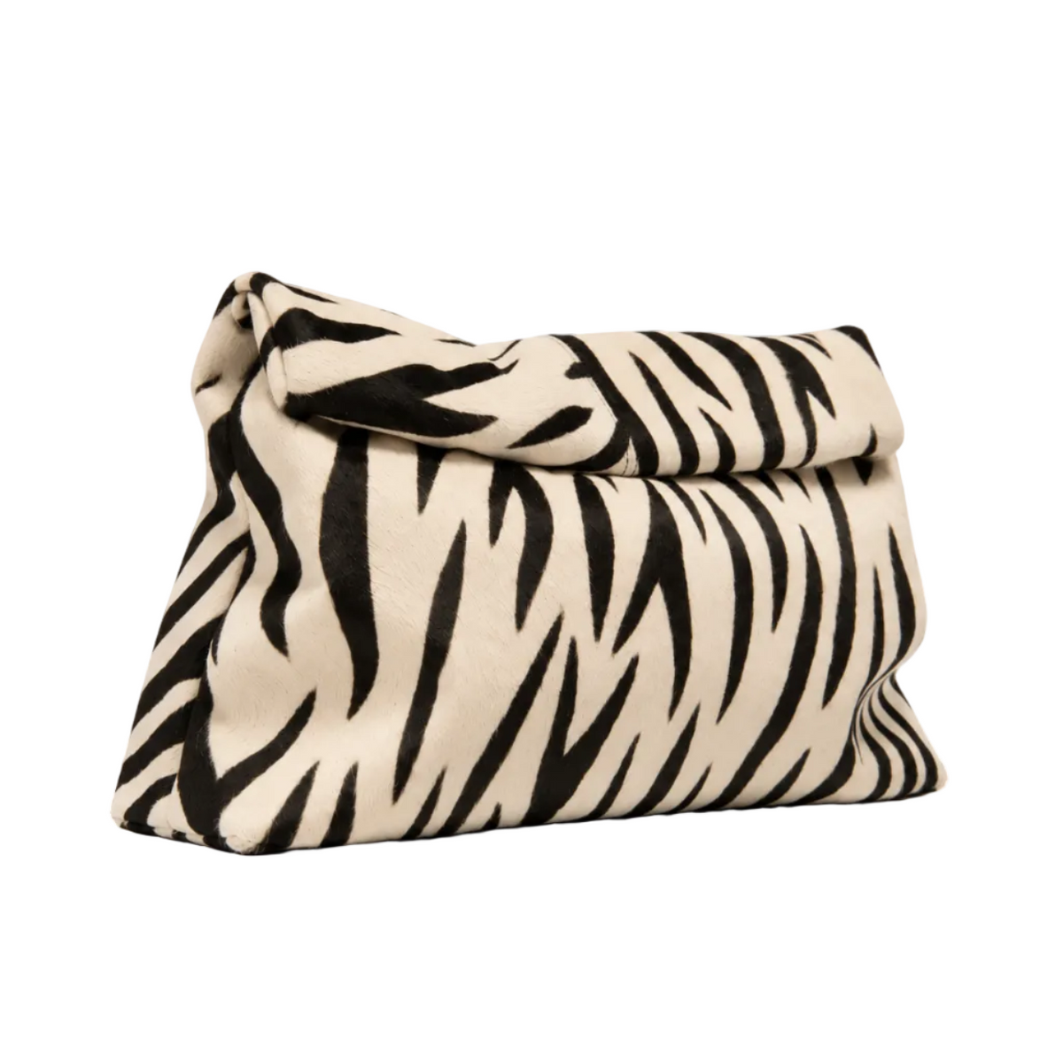 Angled view of The Zebra Clutch by Hostess the label, showing black zebra stripes on cream hide and a folded top.