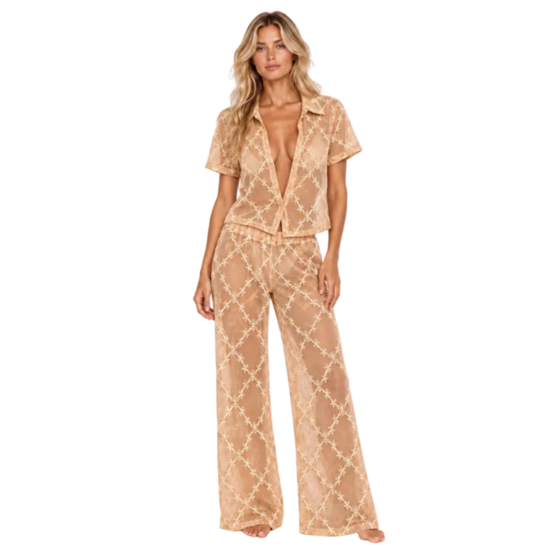 Model wearing The Lace Suit Cover-Up by Hostess the label in peach, with a sheer patterned short-sleeved collared shirt and matching wide-leg pants.