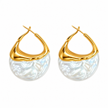 Close-up of The Pearl Drop earrings by Hostess the label, showing curved gold-tone frames and rounded white pearl-like drops.