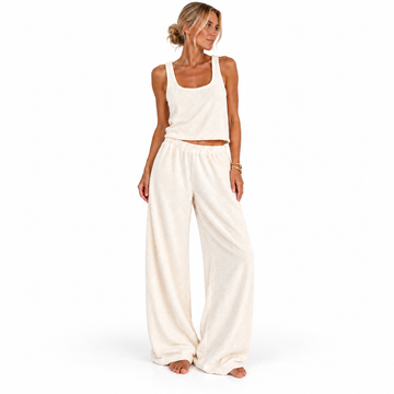 Front view of a model wearing the cream Towelling Loungewear Set, Long, by Hostess the label, with a cropped tank and full-length wide-leg pants.