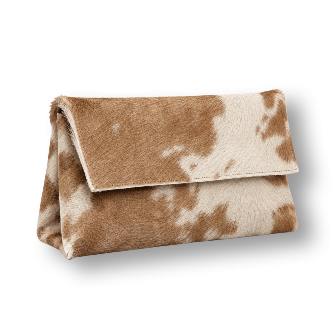 The Hide Clutch in a three-quarter view, with a tan and cream mottled fur-like surface and folded flap on white.